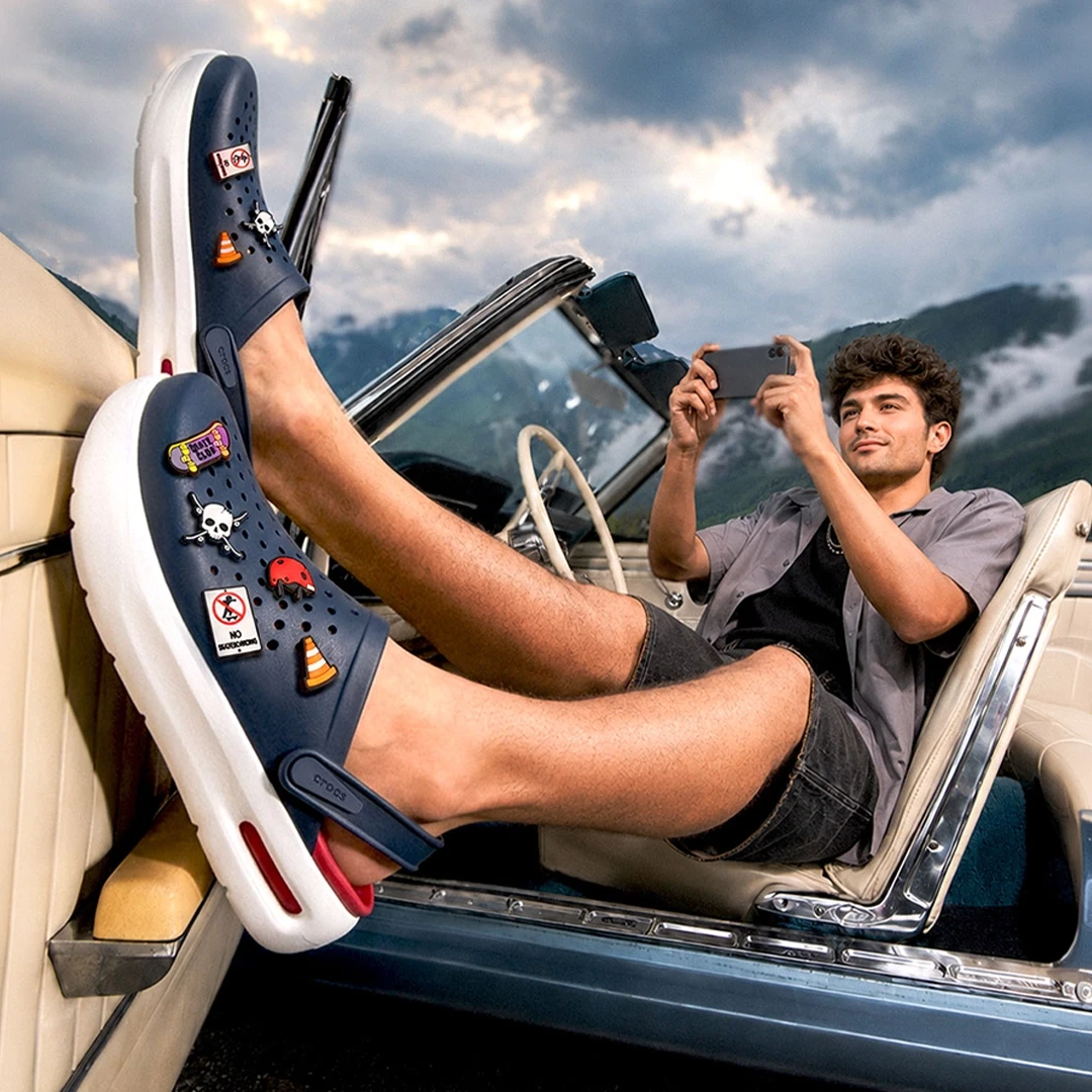Man wearing dark blue crocs